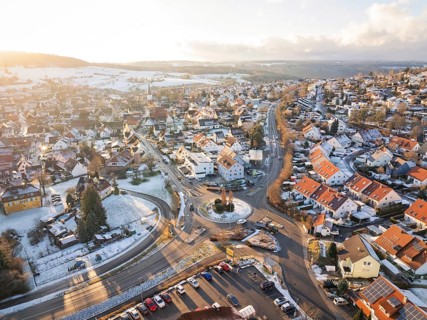 Winter city view with snow-covered streets and a roundabout, Calw- Stammheim, Black Forest,