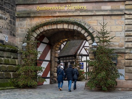 People walking through the Königstor, Christmas trees with fairy lights, Handwerkerhof, Nuremberg,