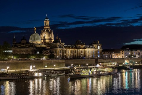City view with Elbe in the evening, steamer departure, illuminated silhouette at the blue hour,