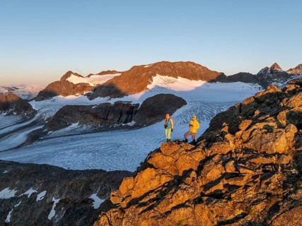 Atmospheric sunrise in a picturesque mountain landscape, alpenglow, aerial view, mountaineer on the