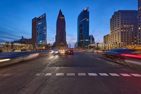 Vehicles with motion blur and light traces, skyscrapers Forum Tower, Kollhoff Tower and railway