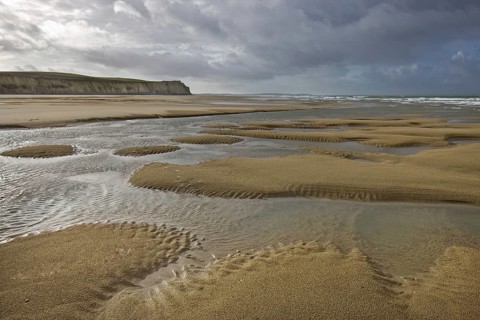 Tide pools on sand beach at low tide at Cap Blanc Nez, Pas-de-Calais, France, Europe