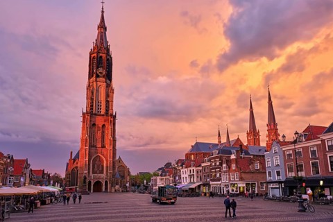 Nieuwe Kerk New Church protestant church on Delft Market Square Markt with dramatic sky on sunset.