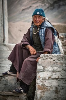 LAMAYURU, INDIA, SEPTEMBER 10, 2011: Old tibetan woman sitting near Lamayuru gompa in Ladakh,