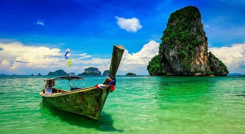Panorama of long tail boat on tropical beach (Pranang beach) and rock, Krabi, Thailand, Asia