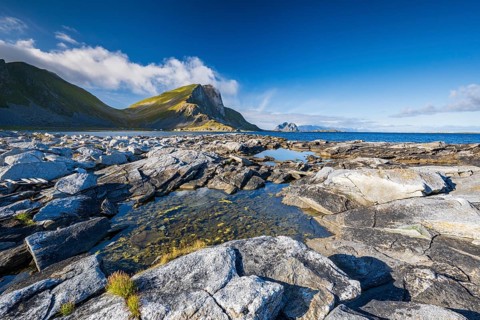 Rocky coast and mountains of the island of Værøy, Vaeroy, Lofoten, Norway, Europe