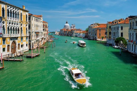 VENICE, ITALY, JULY 19, 2019: View of Venice Grand Canal with boats and Santa Maria della Salute