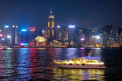 Hong Kong skyline cityscape downtown skyscrapers over Victoria Harbour in the evening illuminated