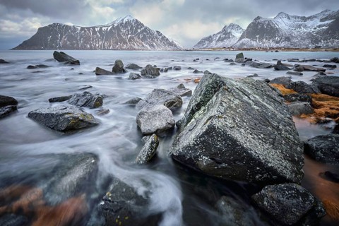 Waves and rocks on coast of Norwegian sea in fjord. Skagsanden beach, Flakstad, Lofoten islands,
