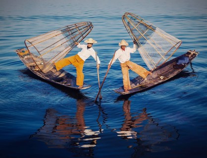 Myanmar travel attraction, Traditional Burmese fishermen balancing with fishing nets at Inle lake