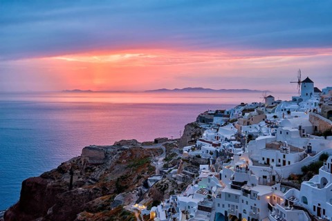 Famous greek iconic selfie spot tourist destination Oia village with traditional white houses and