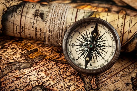 Travel geography navigation concept background, old vintage retro compass on ancient world map