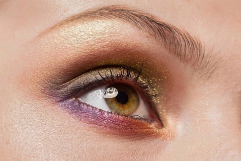 Macro image of human woman eye with make up