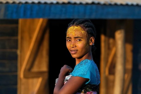 Malagasy girl with sun protection mask made from Musiro root at Begidro near Ankiliroroka, Belo sur