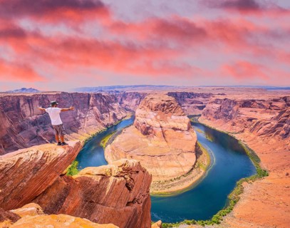 A young man with white shirt and green hat in Horseshoe Bend, Arizona. United States