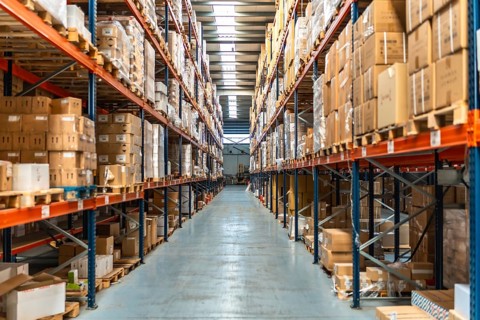 Interior view of an aisle of a distribution warehouse full of packages and no people
