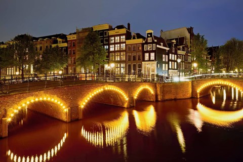 Seven bridges illuminated with neon lights at the corner of Keizersgracht and Reguliersgracht,