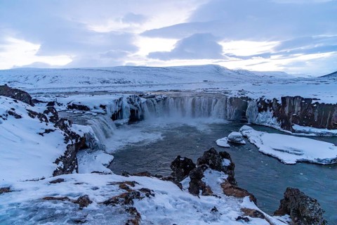 Landscape detail of frozen Godafoss waterfall at sunset in winter, Iceland, Europe