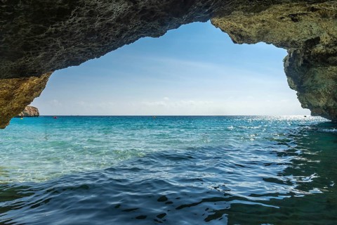 Crystal clear turquoise waters of the mediterranean sea glisten under the summer sun, viewed from