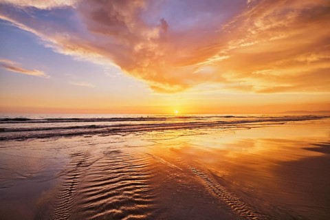 Atlantic ocean sunset with surging waves at Fonte da Telha beach, Costa da Caparica, Portugal,