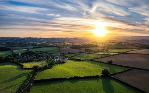 Sunset over Devon Fields from a drone, Berry Pomeroy, England, United Kingdom, Europe