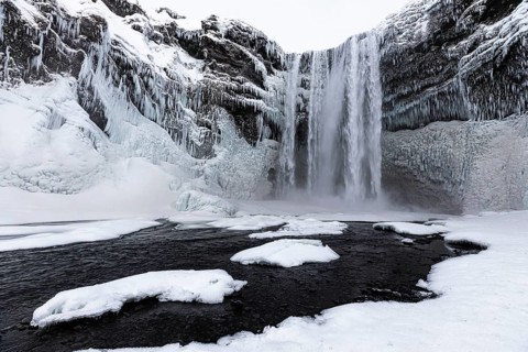 Skogafoss waterfall, snowy and icy rock face, Sudurland, Iceland, Europe