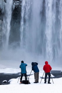 Photographers at Skogafoss waterfall, winter landscape, Sudurland, Iceland, Europe