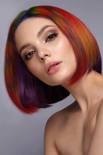 Portrait of beautiful woman with multi-colored hair and creative make up and hairstyle