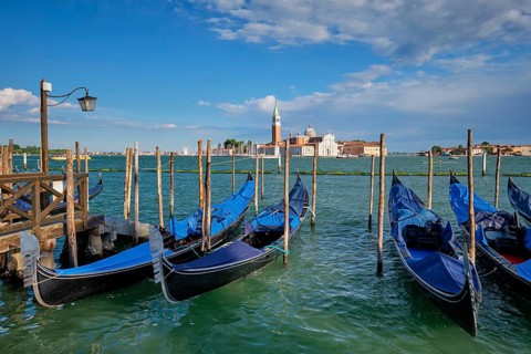 Gondolas and in lagoon of Venice by Saint Mark (San Marco) square with San Giorgio di Maggiore