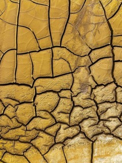 Mineral-rich cracked earth at the bank of the Rio Tinto (Red river), aerial view, drone shot,