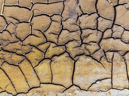 Mineral-rich cracked earth at the bank of the Rio Tinto (Red river), aerial view, drone shot,