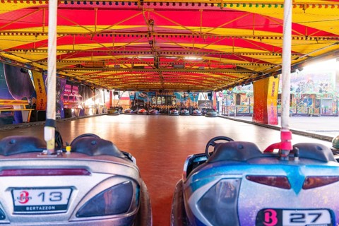 Empty bumper car hall with colourful vehicles, ready for visitors at a carnival, Weil der Stadt,