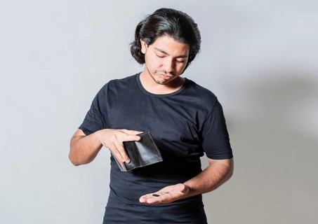 Unhappy man with financial crisis isolated. Person with financial crisis holding wallet. Sad man