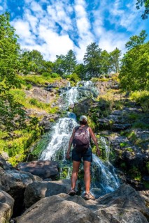 A female backpacker in summer at the Todtnau waterfall in the Black Forest in Germany