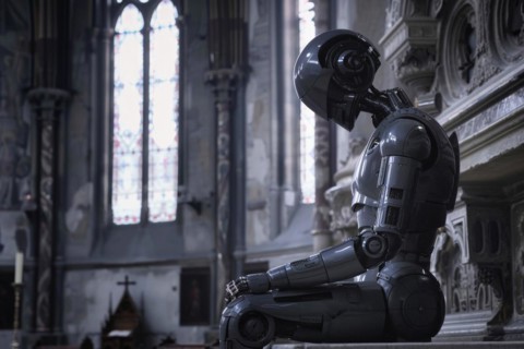 A humanoid sits in a church, signalling devotion and spirituality with its posture, vision of the