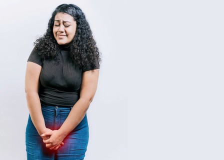 Young woman with urinary problems isolated. Girl with hands on crotch with urinary problems. People