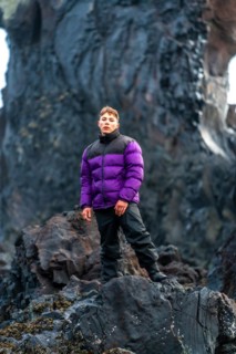 Portrait of an adventurous young man on Djupalonssandur beach in winter in Iceland