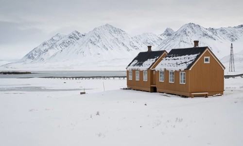 Ochre-coloured houses, research settlement, scientific settlement, wintry mountain landscape,