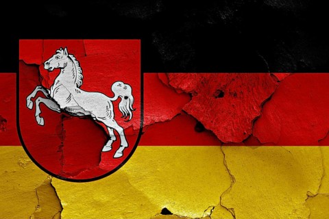 Flags of Lower Saxony and Germany painted on cracked wall