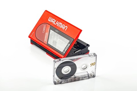 WETZLAR, Germany: 2022-04-16: Beautiful red vintage SONY WALKMAN WM-24 with audio tape over bright