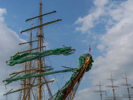 The masts and sails of a large sailing ship against a blue sky with few clouds, bremerhaven,