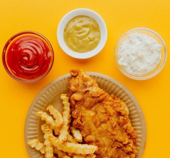 Top view fish chips plate with sauces