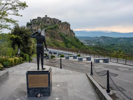 Sculpture with a view of the hilltop village of Civita di Bagnoregio, Lazio, Italy, Europe