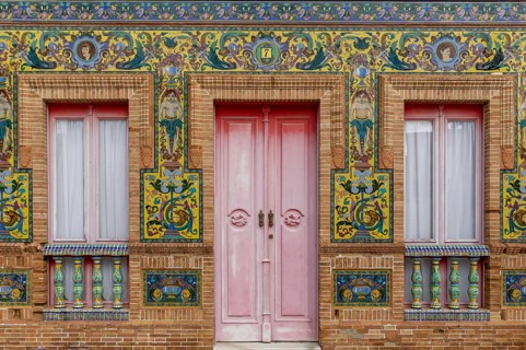 Isla Cristina, Spain - 7 January 2021: colorful tile and red brick house front in detail