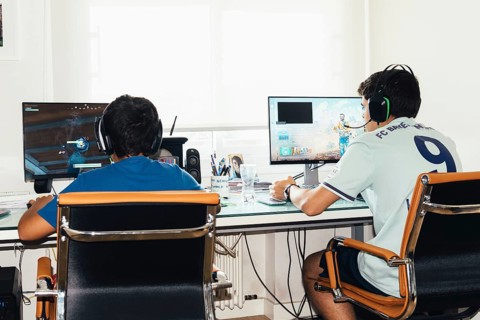 Madrid, Spain, August 23, 2019: Teenagers playing Fortnite video game and CSGO Counter Strike on PC