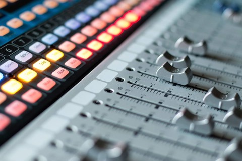 Professional music production in a sound recording studio, mixer desk