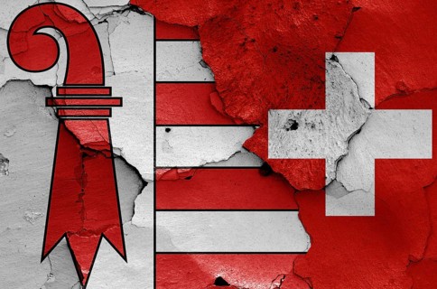 Flags of Jura canton and Switzerland painted on cracked wall