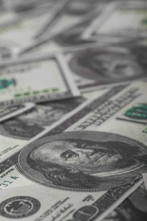 One hundred US dollars bills pile. Selective focus