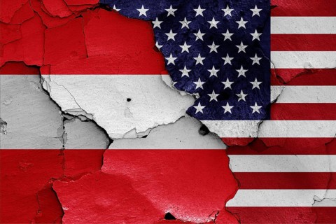 Flags of Austria and USA painted on cracked wall