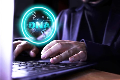 DNA research. Hands of a business man using the computer doing research and work on DNA. Concept of